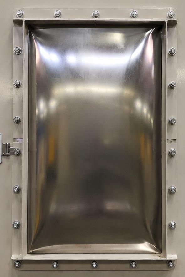 Deflagration panel on a Winona Van Norman Bag House Style Dust Collector, designed to safely relieve pressure in the event of a combustible dust explosion.