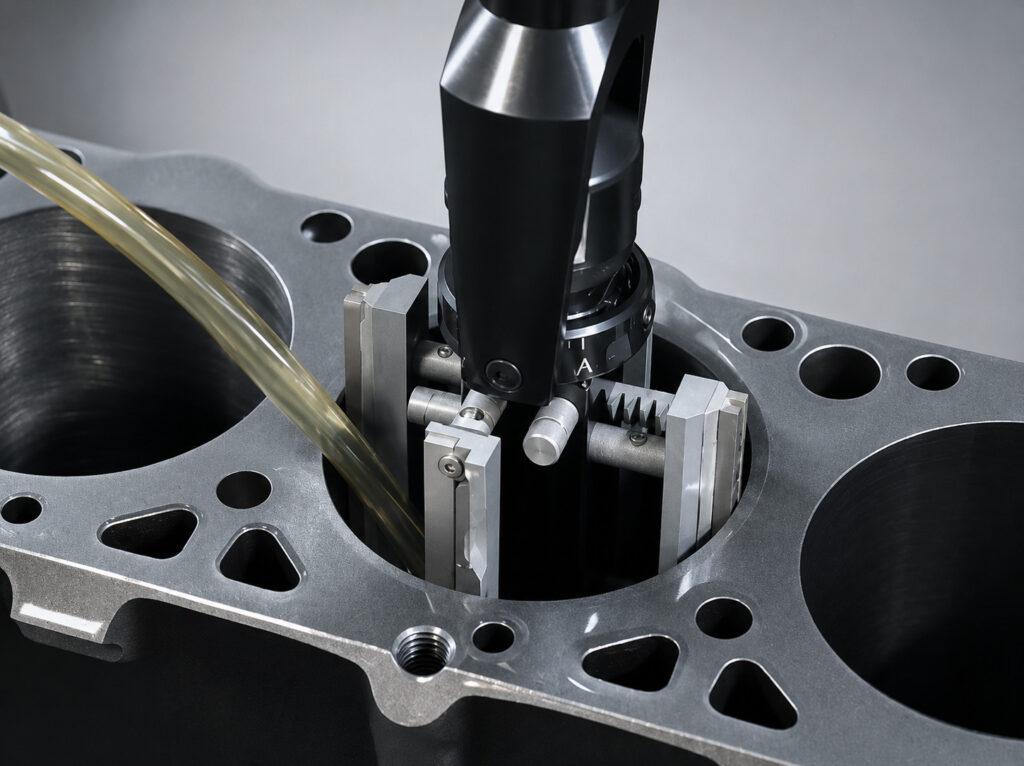 Action shot of the Winona Van Norman PS2V Power Stroke Hone actively honing a cylinder bore, showcasing the honing head in operation and precision machining performance.