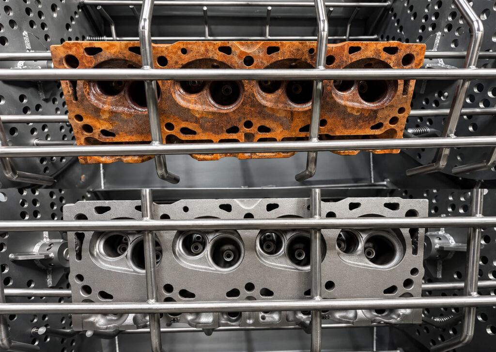 Side-by-side comparison of engine blocks before and after cleaning in a Winona Van Norman Fixed Basket Blaster, showing the removal of rust, scale, grease, and surface contaminants.