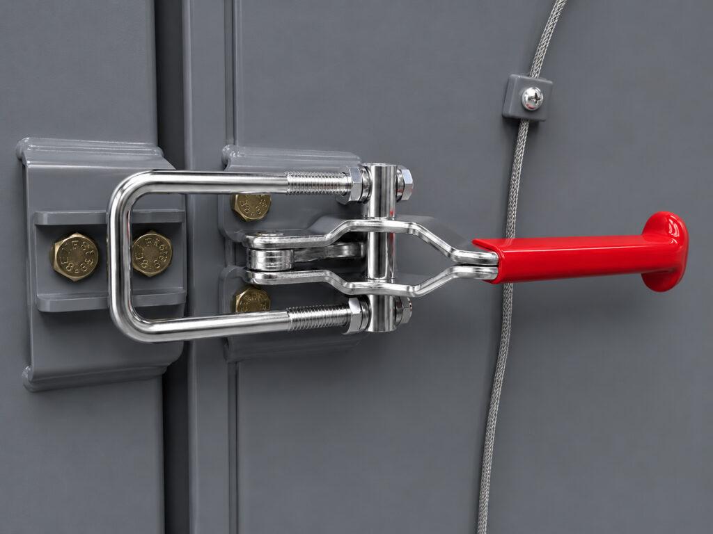 Close-up of the door lock on a Winona Van Norman Table Washer securing the access door during the cleaning cycle.