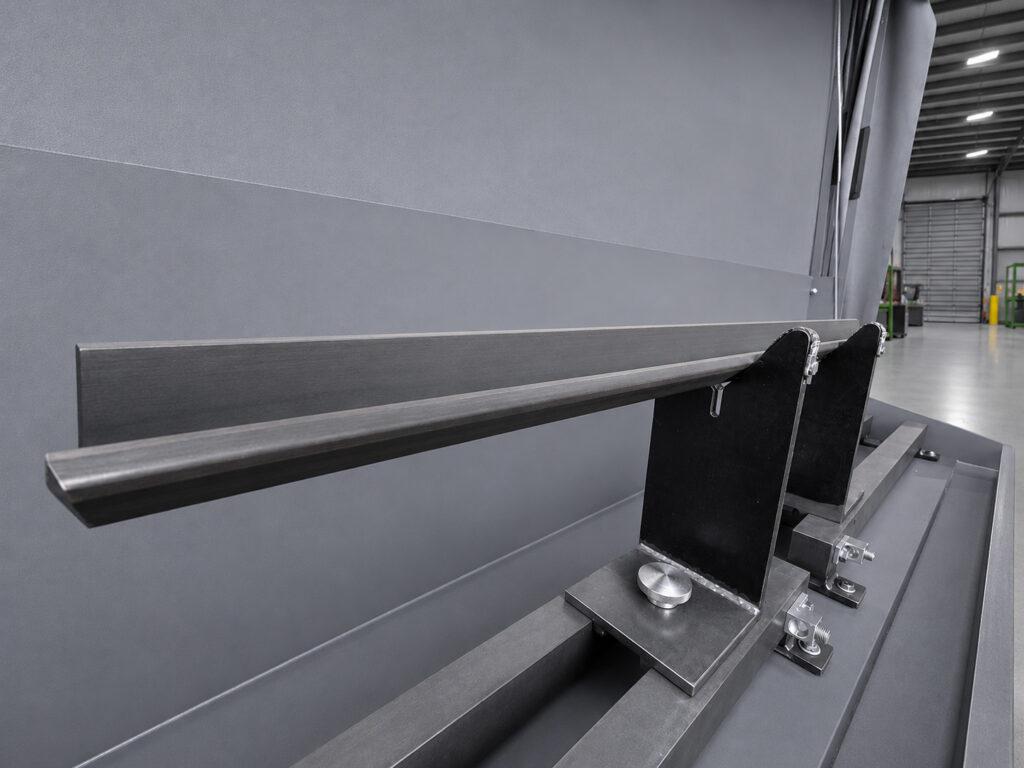 Holding bar of the Winona Van Norman MPI Magnetic Particle Inspector designed to securely support engine components during magnetic particle inspection.