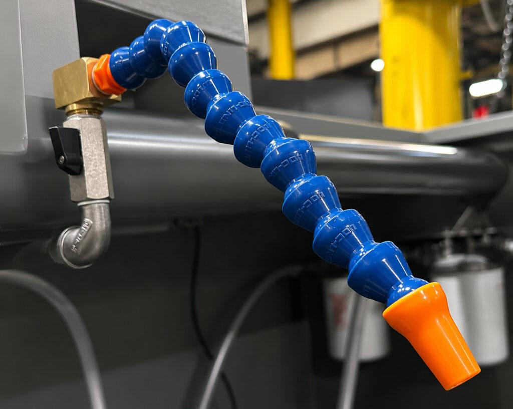 Close-up view of the hose on the Winona Van Norman PS2V Power Stroke Hone supplying honing fluid to the honing head for cooling, lubrication, and debris removal.