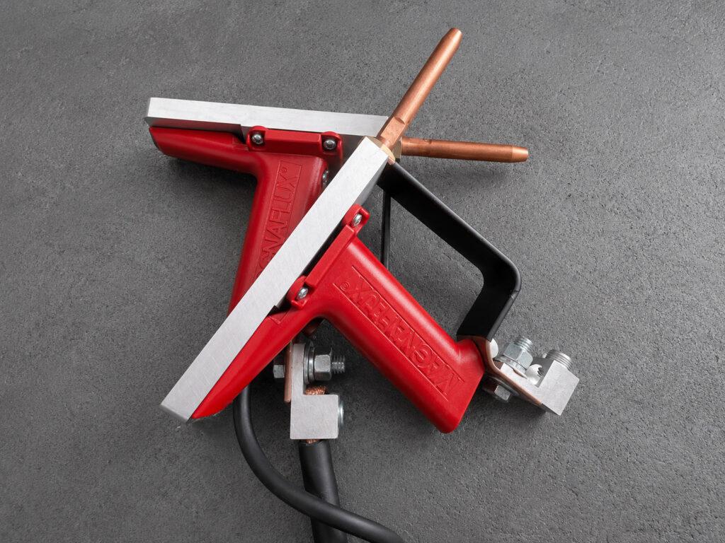 Spray guns on the Winona Van Norman MPI Magnetic Particle Inspector used to evenly apply magnetic particle inspection solution to ferrous engine components.