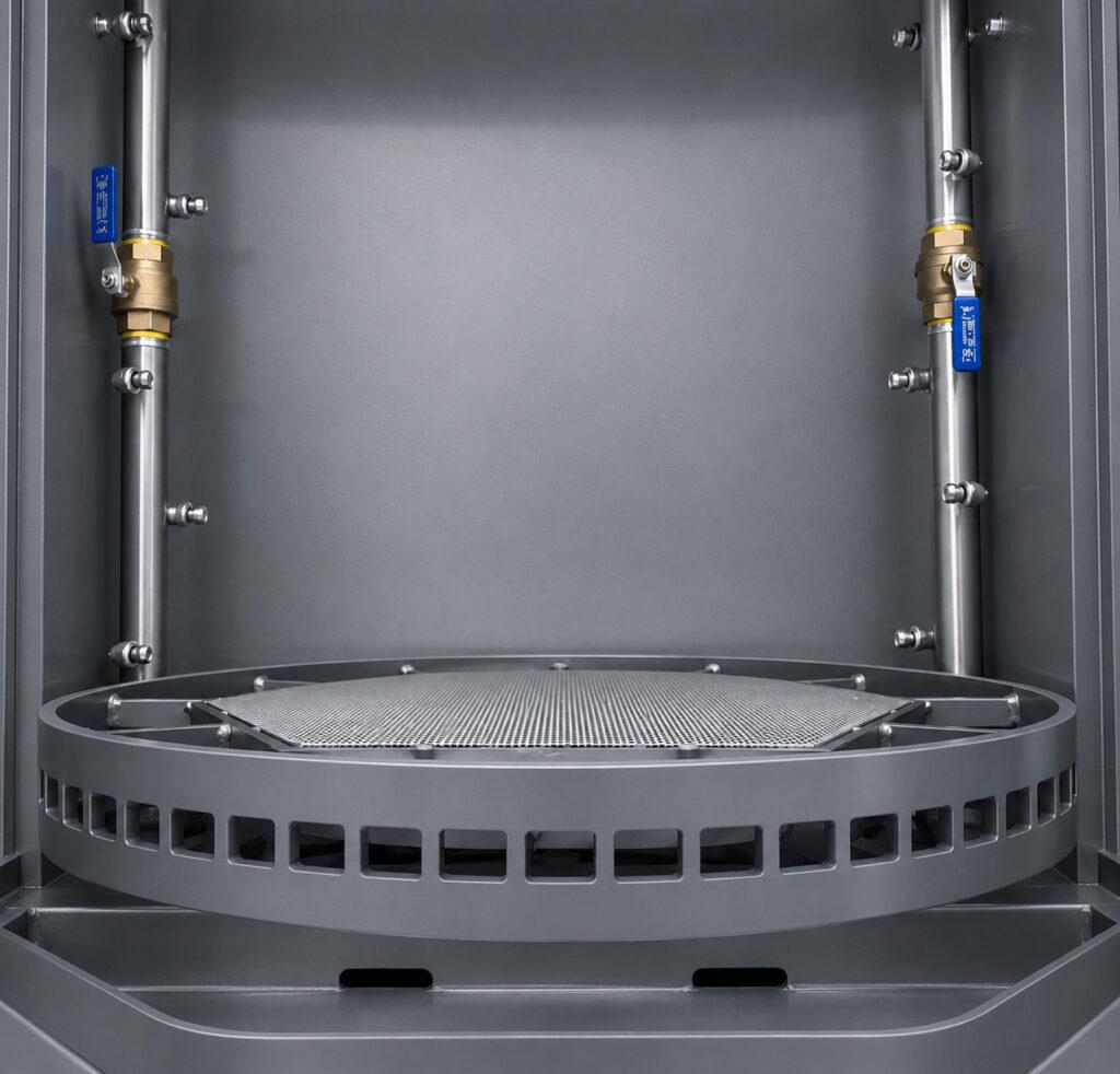 Close-up of the rotating table inside a Winona Van Norman Table Washer supporting engine components during the cleaning cycle.