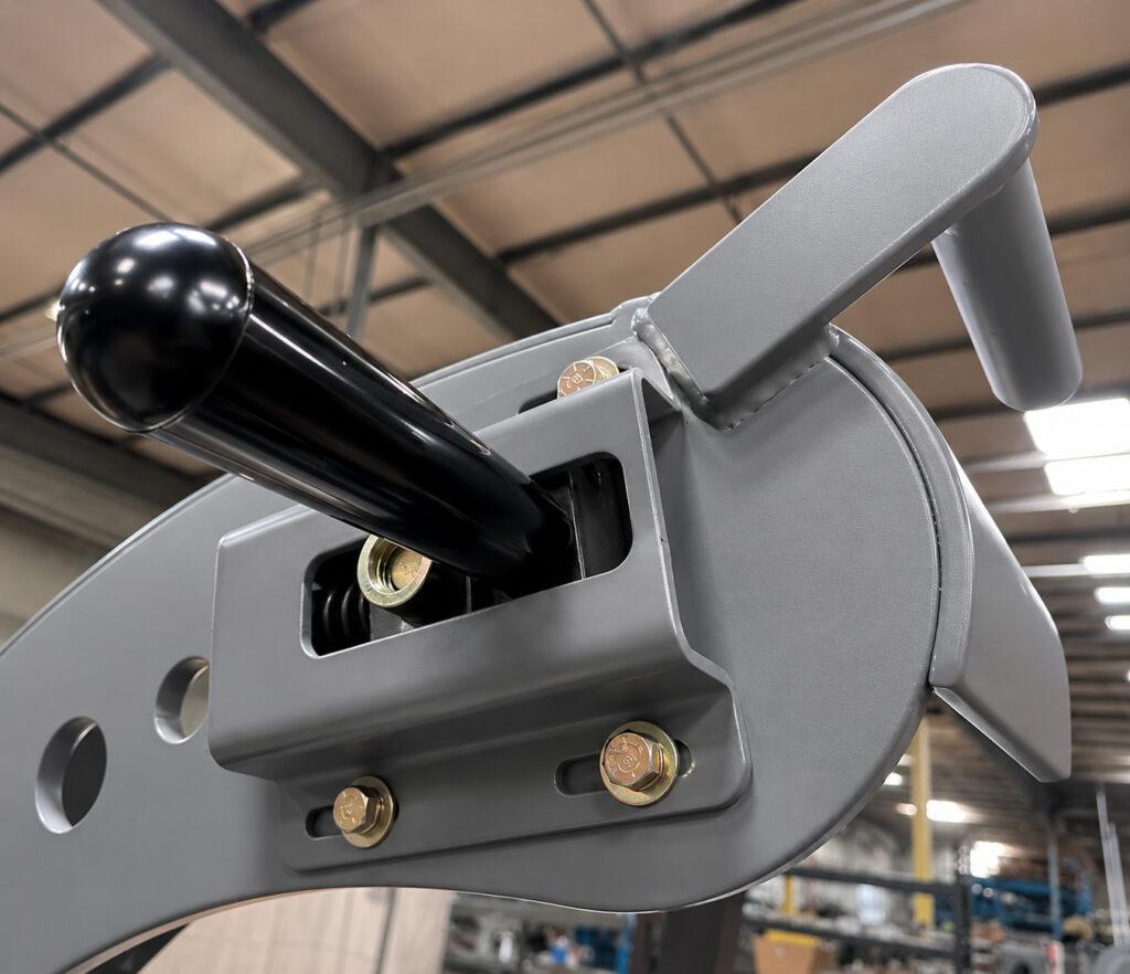 Close-up of the manual operating handle on the polishing arm of a Winona Van Norman Crankshaft Polisher used for precise operator control during polishing.