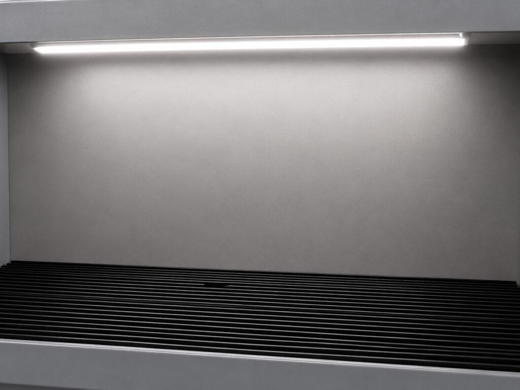 Close-up of the integrated light workstation on a Winona Van Norman Grinding Bench providing enhanced visibility during precision grinding.
