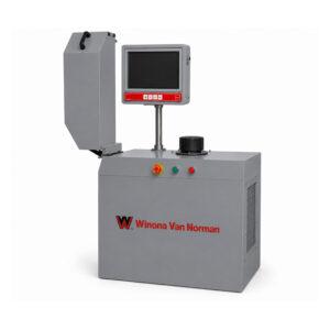 Slight angle view of a Winona Van Norman Crankshaft Balancer featuring precision roller supports, measuring system, operator controls, and heavy-duty construction for accurate crankshaft balancing.
