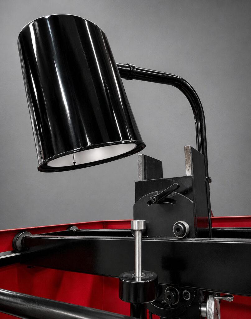 Close-up of the integrated work light on a Winona Van Norman Disassembly Bench providing bright illumination for precision engine component servicing.