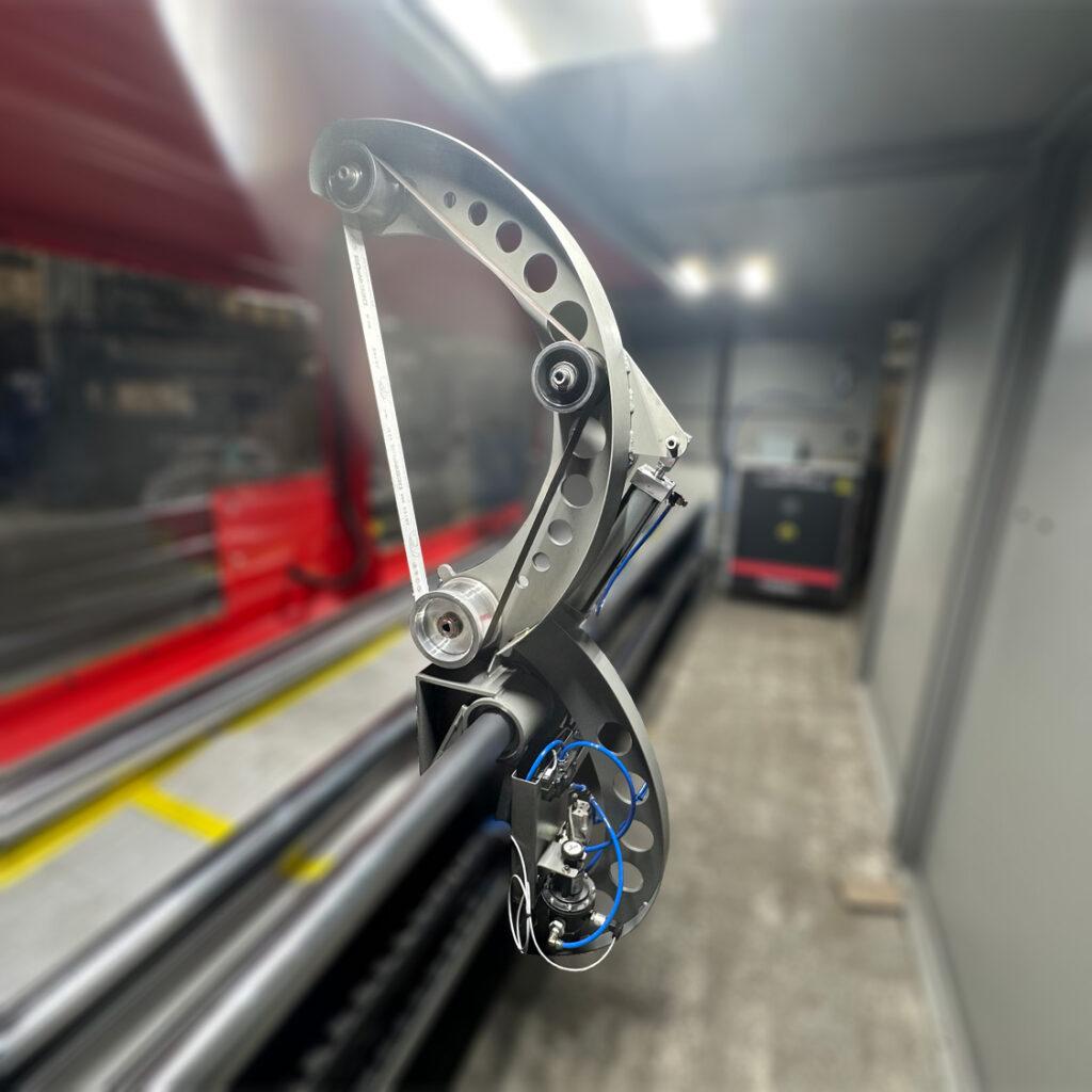 Polisher arm on an automated crankshaft polisher showing precision finishing head used to apply consistent pressure and motion for polishing crankshaft surfaces.