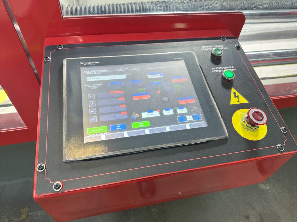 HMI/PLC control interface on an automated crankshaft polisher showing touchscreen display and control panel used to monitor and manage polishing cycles and machine operations.