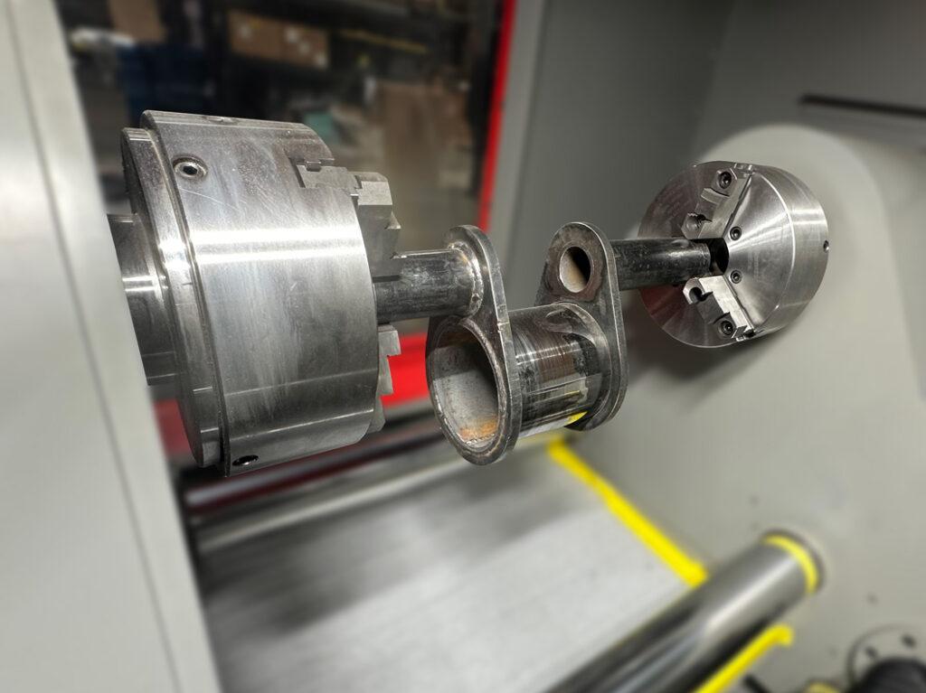 Crankshaft holder on an automated crankshaft polisher securing the crankshaft in place during polishing for stable, precise, and consistent surface finishing.