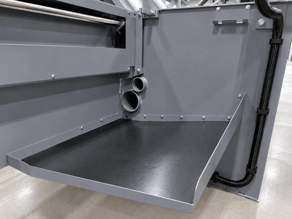 Drainage tray on the Winona Van Norman LH3X Line Hone designed to collect honing oil and fluid during precision line honing of engine block main bearing bores.